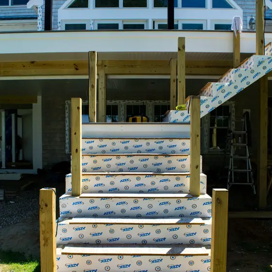 New deck stairs being built, treads wrapped for protection during construction