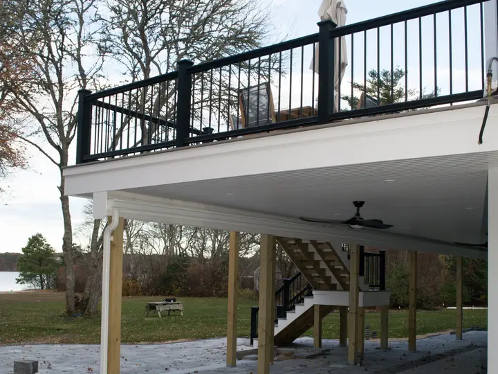 Elevated composite deck with black railing overlooking the water, built by Murray Building & Remodeling